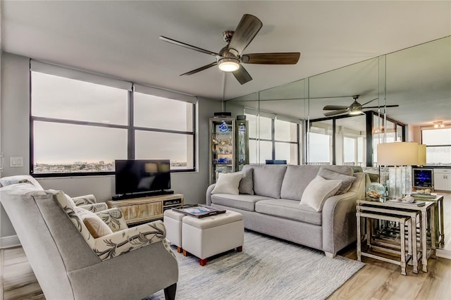 living room featuring ceiling fan and light hardwood / wood-style flooring