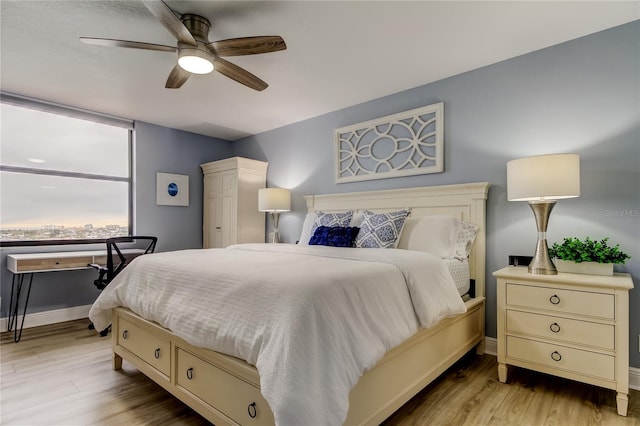 bedroom featuring light hardwood / wood-style floors and ceiling fan