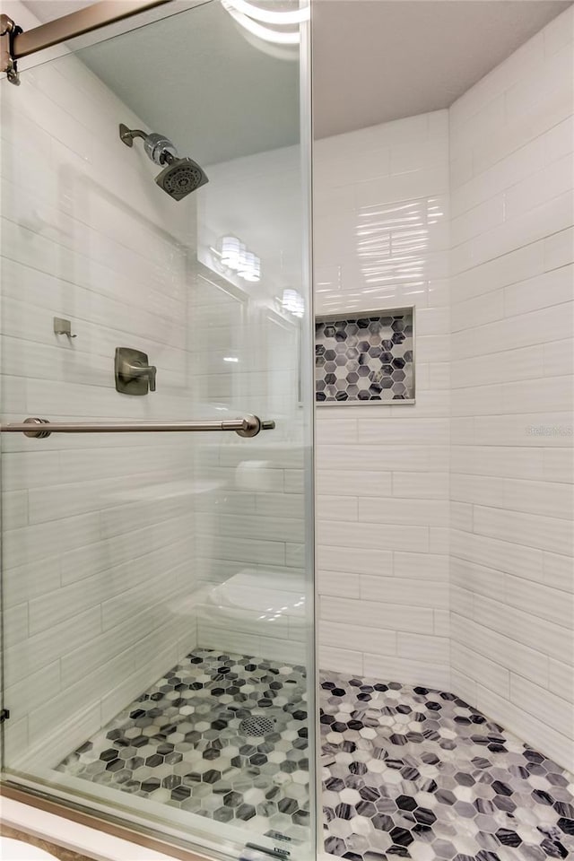 bathroom with a shower with shower door