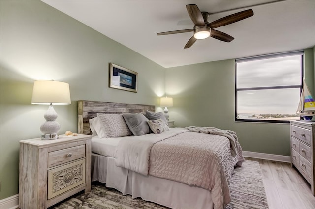 bedroom with ceiling fan and light hardwood / wood-style flooring