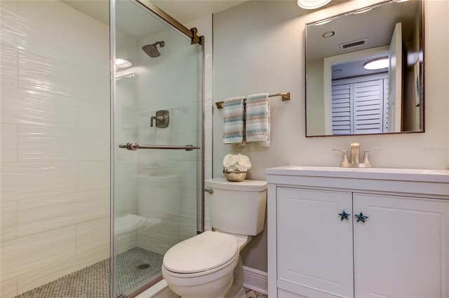 bathroom featuring walk in shower, vanity, and toilet