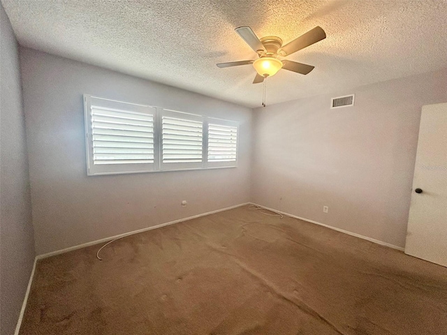 unfurnished room featuring ceiling fan, carpet, and a textured ceiling