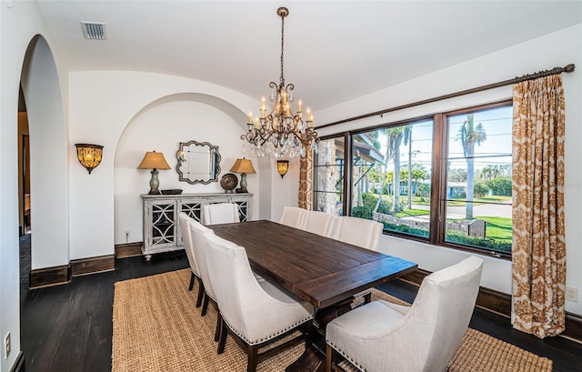 dining area with arched walkways, visible vents, baseboards, vaulted ceiling, and dark wood-style floors