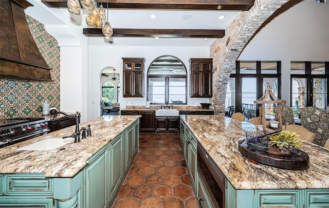 kitchen with a center island, green cabinetry, and light stone countertops