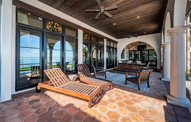 view of patio / terrace with ceiling fan and an outdoor living space