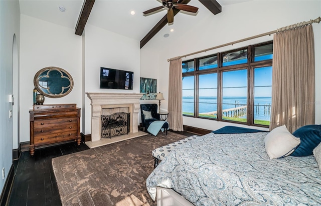 bedroom with baseboards, dark wood-style flooring, beamed ceiling, a fireplace, and high vaulted ceiling