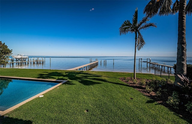 view of dock with a water view and a yard