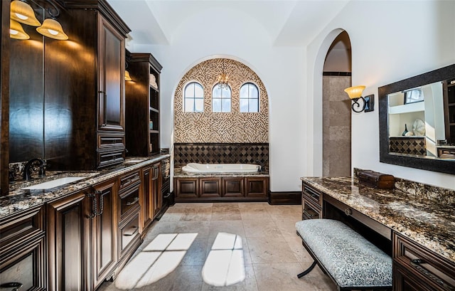 full bathroom featuring a garden tub and vanity