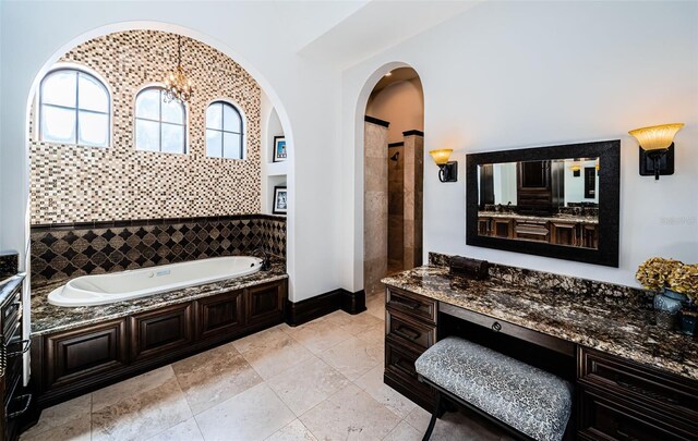 bathroom with tiled shower, tile patterned flooring, vanity, and a bath