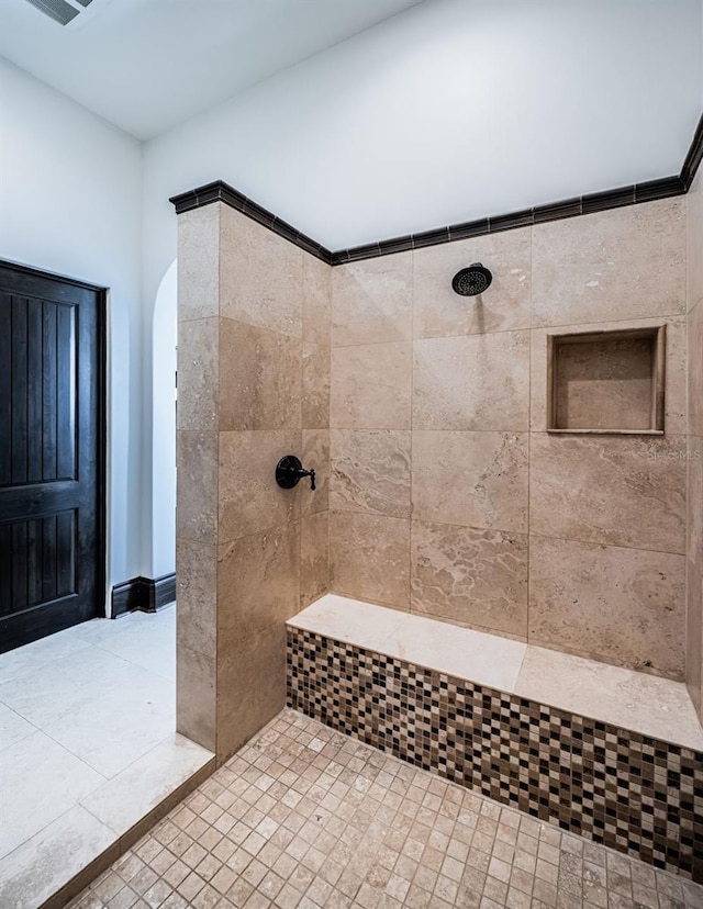 bathroom featuring a tile shower