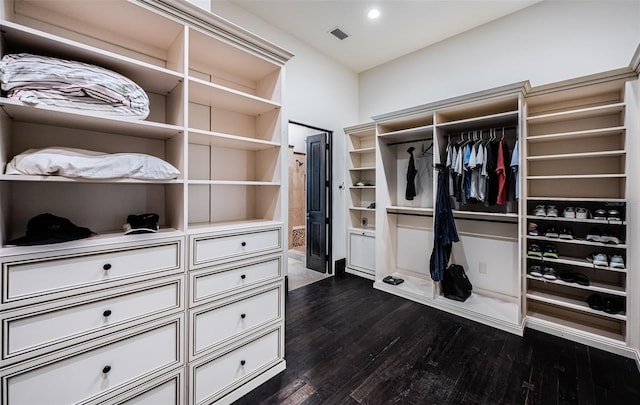 spacious closet featuring dark wood-style flooring and visible vents