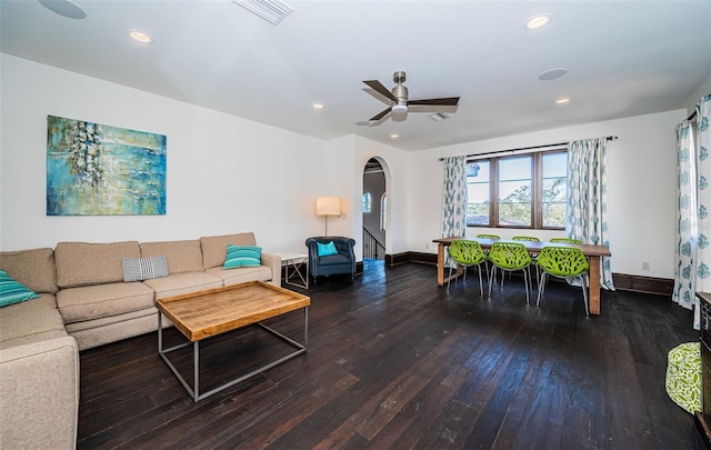 living room featuring arched walkways, dark wood finished floors, recessed lighting, ceiling fan, and baseboards