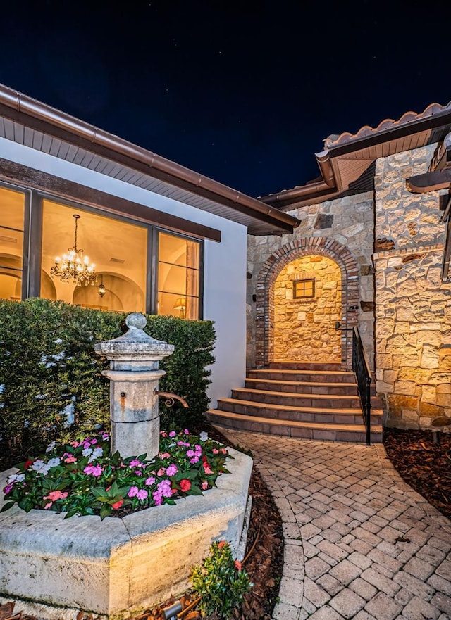 entrance to property featuring stone siding