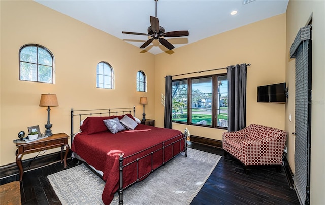 bedroom featuring a ceiling fan, recessed lighting, baseboards, and wood finished floors