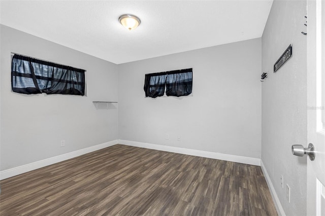 spare room with dark hardwood / wood-style flooring