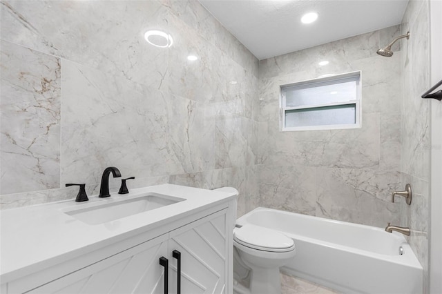 full bathroom featuring shower / washtub combination, toilet, tile walls, and vanity