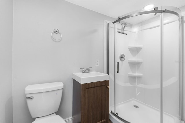 bathroom featuring toilet, walk in shower, and vanity