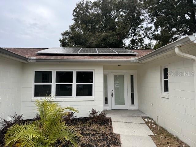 doorway to property featuring solar panels