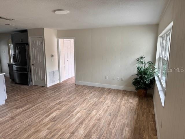 unfurnished living room with hardwood / wood-style flooring