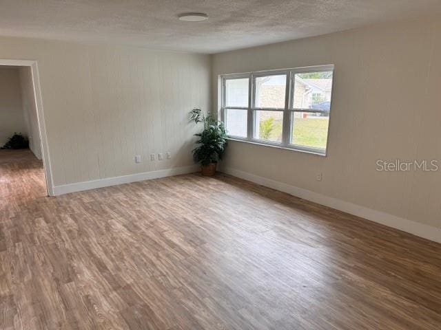 spare room featuring hardwood / wood-style floors