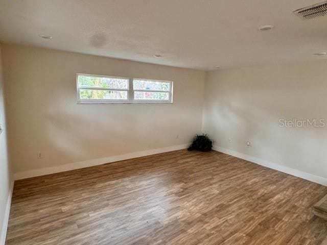 unfurnished room with hardwood / wood-style floors