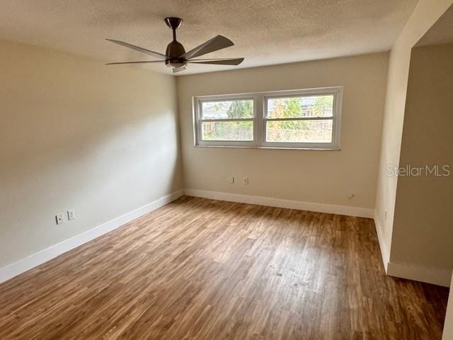 spare room with hardwood / wood-style floors, a textured ceiling, and ceiling fan