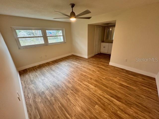 unfurnished room featuring ceiling fan and wood-type flooring