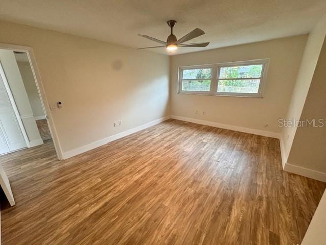 unfurnished room featuring ceiling fan and hardwood / wood-style floors