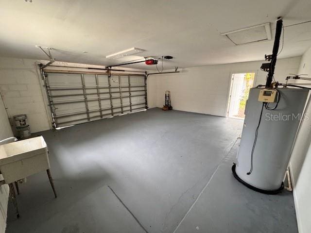 garage with a garage door opener and water heater