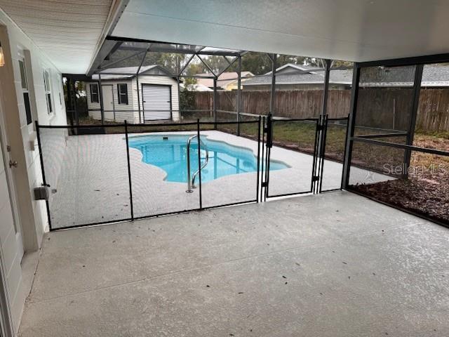 view of pool featuring a patio area and a shed