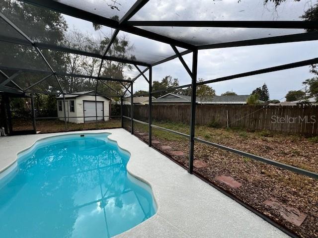 view of pool with a storage shed