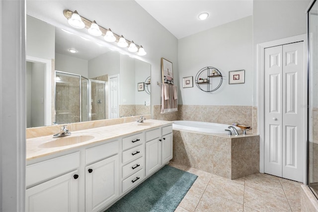 bathroom featuring vanity, tile patterned floors, and plus walk in shower