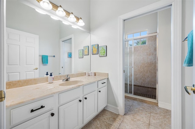 bathroom with vanity, an enclosed shower, and tile patterned flooring