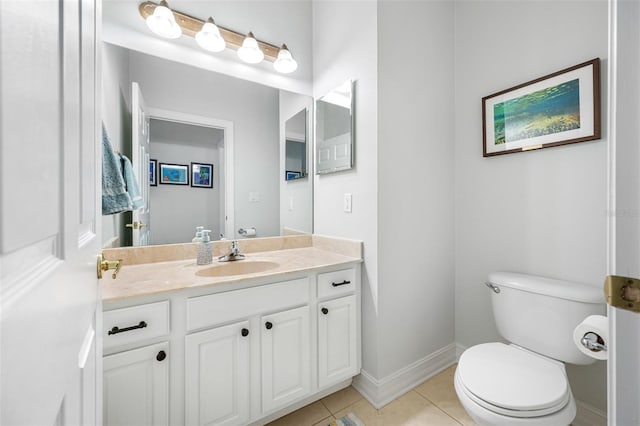 bathroom with toilet, tile patterned floors, and vanity