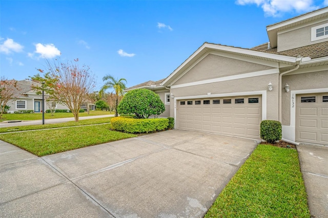 view of side of home featuring a lawn and a garage