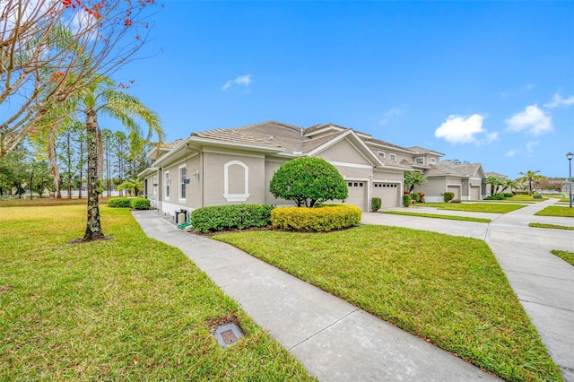 view of front of home featuring a front yard and a garage