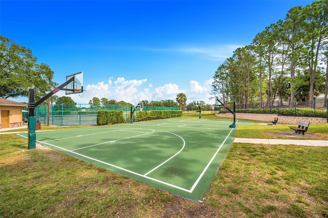 view of sport court with a yard