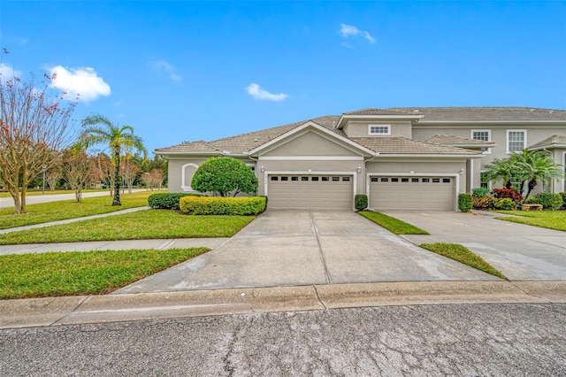 view of front of home with a garage and a front lawn