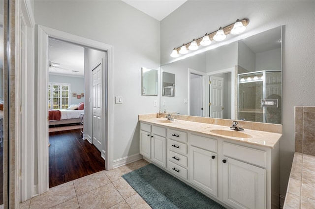 bathroom featuring tile patterned flooring, walk in shower, and vanity