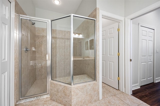 bathroom featuring tile patterned floors and an enclosed shower