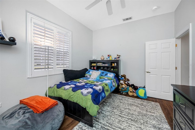 bedroom with ceiling fan and dark wood-type flooring