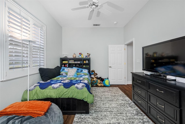 bedroom with ceiling fan and dark hardwood / wood-style flooring