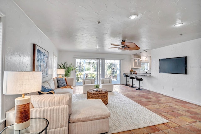 living room with sink and ceiling fan