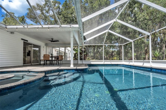 view of swimming pool featuring a lanai, a patio, ceiling fan, and an in ground hot tub