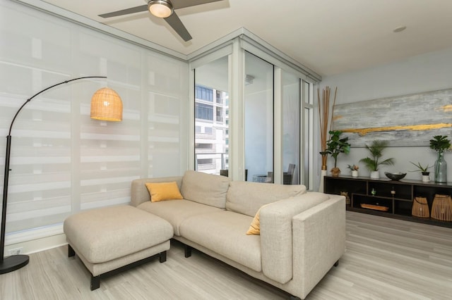 living room with hardwood / wood-style floors and ceiling fan