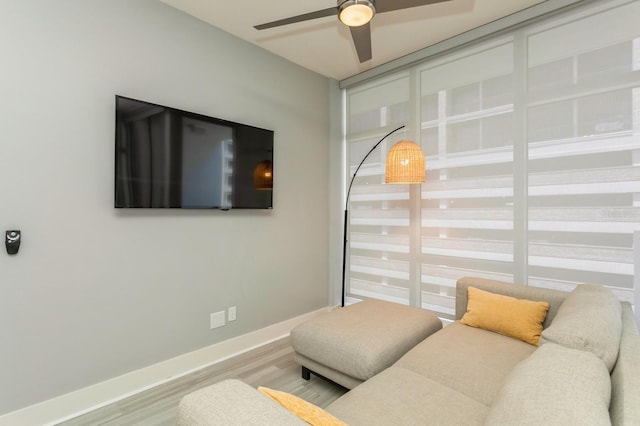 living room featuring ceiling fan and wood-type flooring