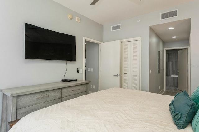 bedroom with a closet, ceiling fan, and ensuite bathroom