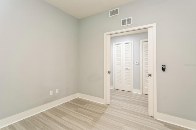 empty room with light hardwood / wood-style floors