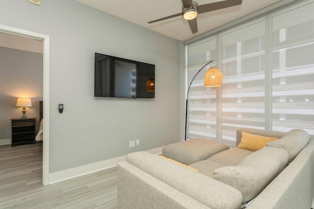 living room featuring wood-type flooring and ceiling fan