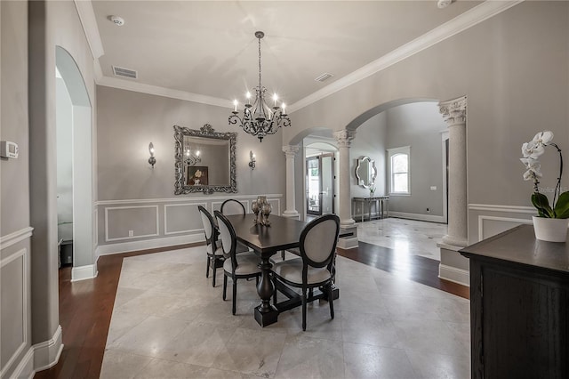 dining area featuring decorative columns and ornamental molding